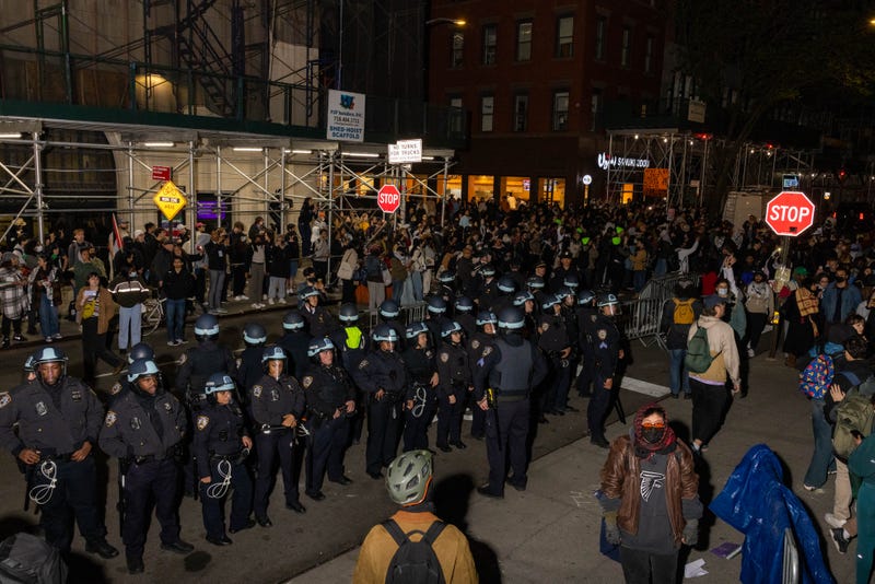 NYPD officers stand by after detaining demonstrators and clearing an encampment on April 22, 2024