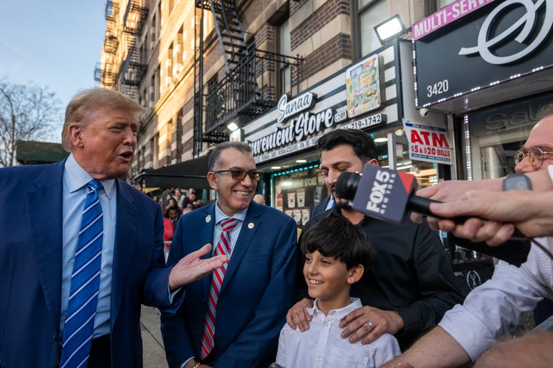 Former president Donald Trump stands with local politicians and bodega workers as he visits a bodega store in upper Manhattan where a worker was assaulted by a man in 2022 and ended up killing him in an ensuing fight on April 16, 2024