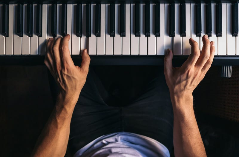 Top view of a man playing piano