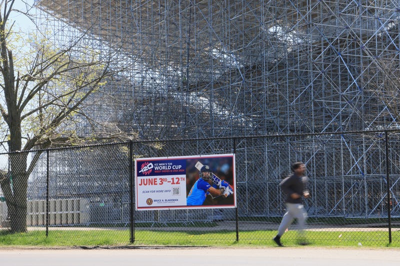 Pedestrians move past the construction site as work continues on the Nassau County International Cricket Stadium at Eisenhower Park on April 22, 2024 in East Meadow, New York. The site will be the host to the ICC World Cup 2024 in June of this year.