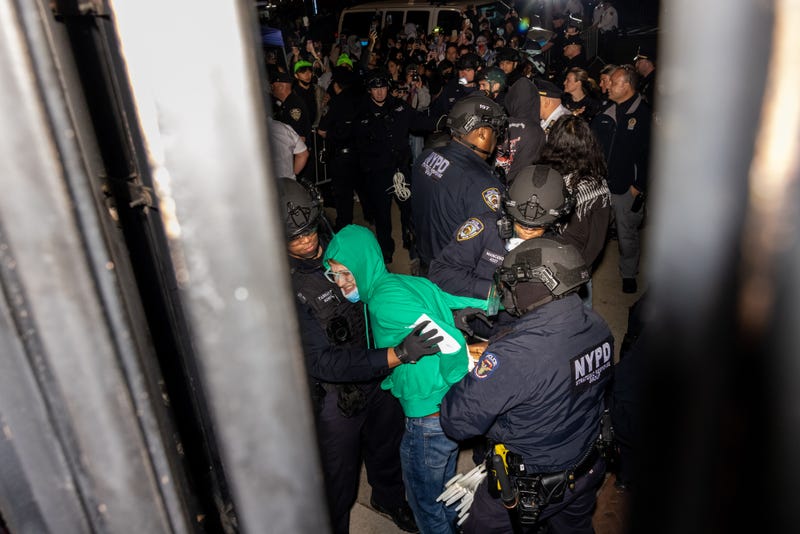Members of the NYPD arrest protesters blocking the entrance to Columbia University while clearing the pro-Palestinian protest encampment and Hamilton Hall on April 30, 2024