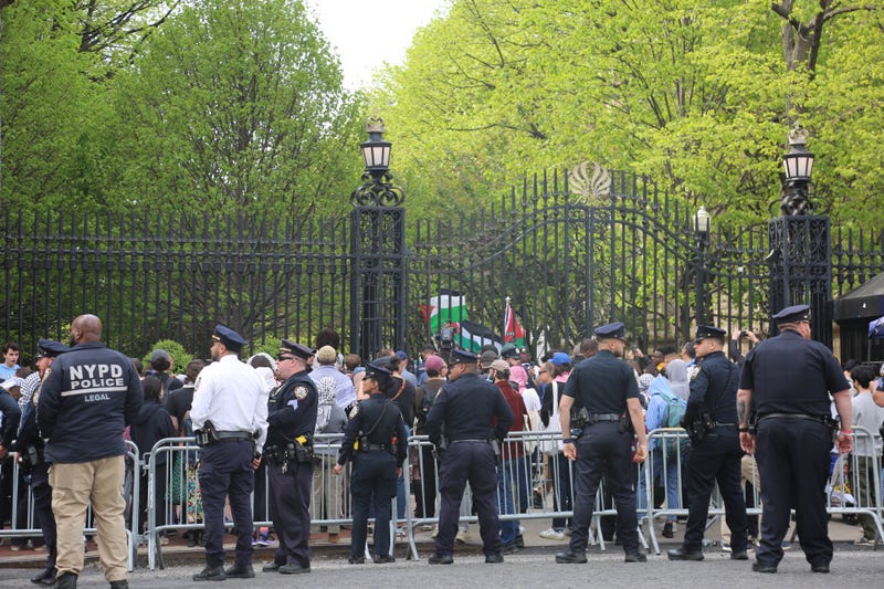 Police officers stand at Columbia University's gate on April 30, 2024