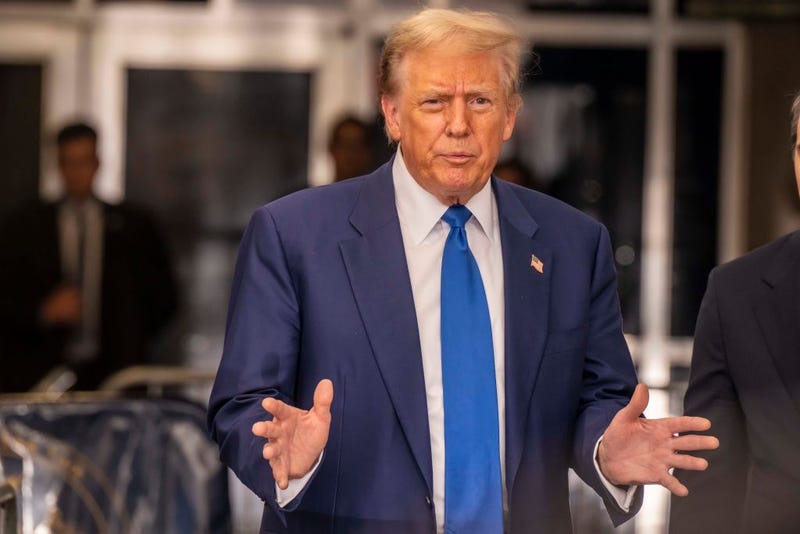 Former President Donald Trump with his lawyers talks to the press pool outside Manhattan Criminal Court room during his trial for allegedly covering up hush money payments at Manhattan Criminal Court on May 3, 2024 in New York City.