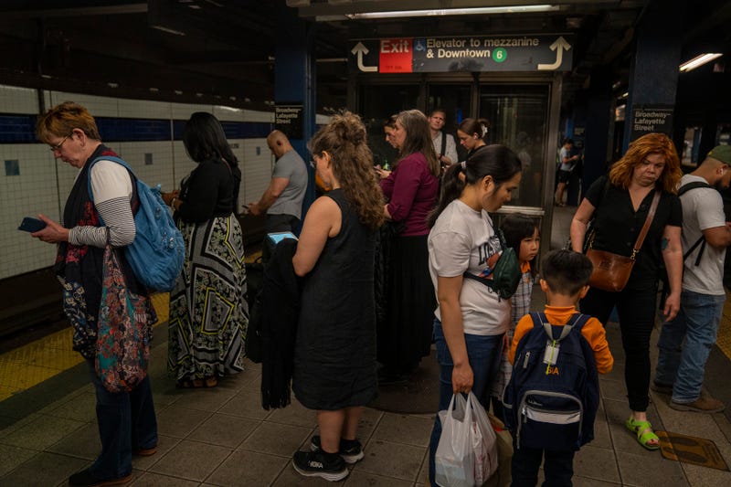 Subway passengers wait for a downtown train at the Broadway–Lafayette Street/Bleecker Street station on April 29, 2024