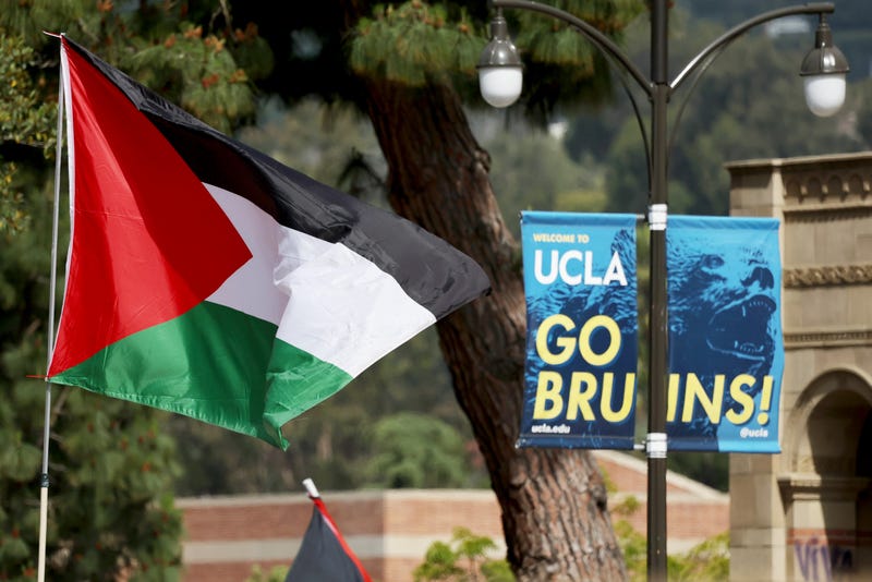 The Palestinian flag flies at a pro-Palestinian encampment, the morning after it was attacked by counter-protestors at the University of California, Los Angeles (UCLA) campus, on May 1, 2024 in Los Angeles, California. A group of counter-protestors attacked the camp overnight leaving some demonstrators wounded. The camp was declared ‘unlawful’ by the university yesterday and classes have been cancelled today due to the violence. Pro-Palestinian encampments have sprung up at college campuses around the country with some protestors calling for schools to divest from Israeli interests amid the ongoing war in Gaza.