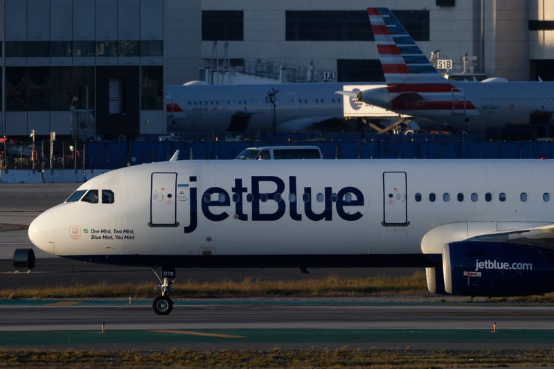 A JetBlue plane taxis at Los Angeles International Airport