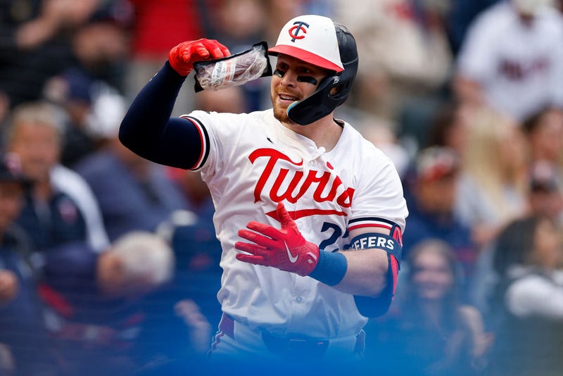 Ryan Jeffers #27 of the Minnesota Twins celebrates a home run with a celebratory sausage.
