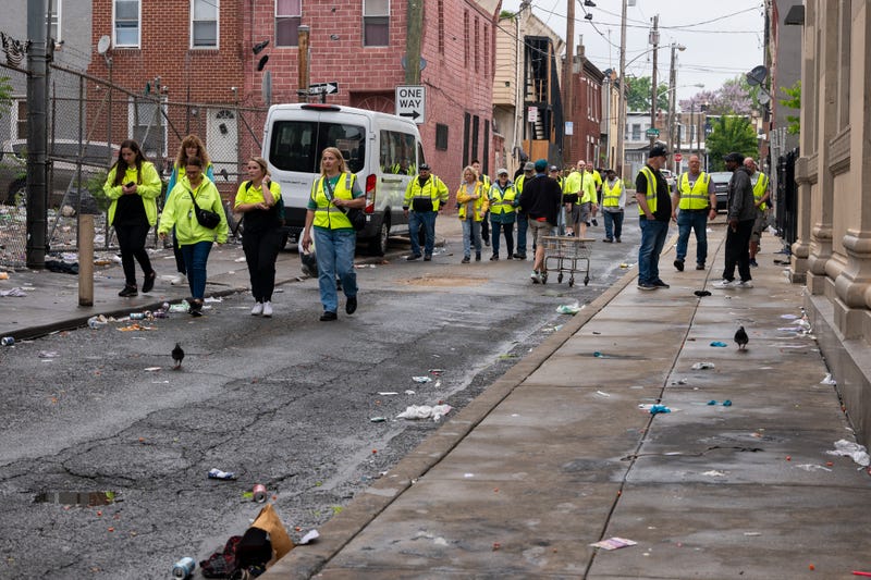 Aid workers walk down a side street in Kensington on May 8, 2024, the day the city cleared out encampments along Kensington Avenue. 
