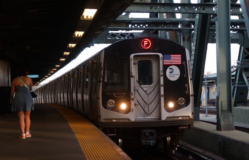 A woman was found dead on a Queens F train on Saturday afternoon, officials said.