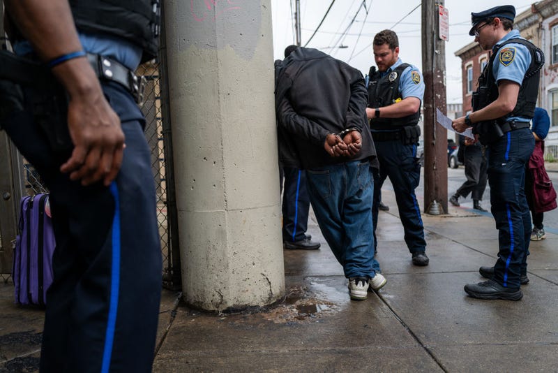 Police arrest a man as the city of Philadelphia begins a long anticipated clearing of an encampment of drug users in active addiction in the Kensington neighborhood on May 8, 2024.