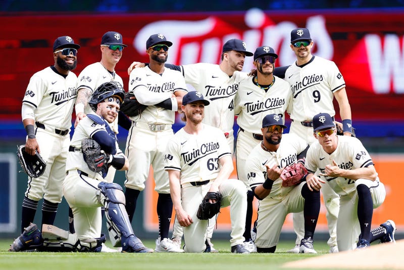 The Twins celebrate their victory as they pose for a photo after the game against the Seattle Mariners at Target Field after they defeated the Mariners 11-1. 