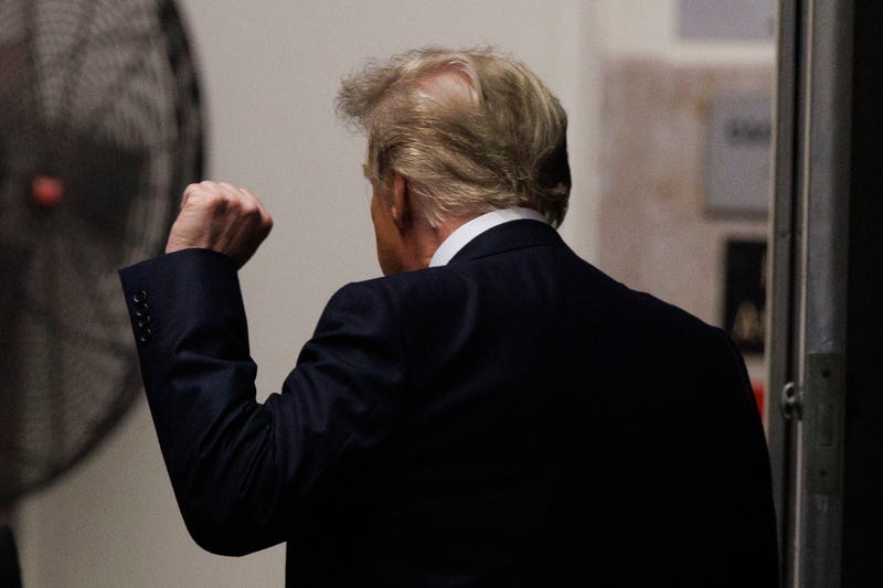 Former U.S. President Donald Trump raises his fist as he leaves for a lunch break during his trial for allegedly covering up hush money payments at Manhattan Criminal Court on May 13, 2024 in New York City. Former U.S. President Donald Trump faces 34 felony counts of falsifying business records in the first of his criminal cases to go to trial. (Photo by Sarah Yenesel-Pool/Getty Images)