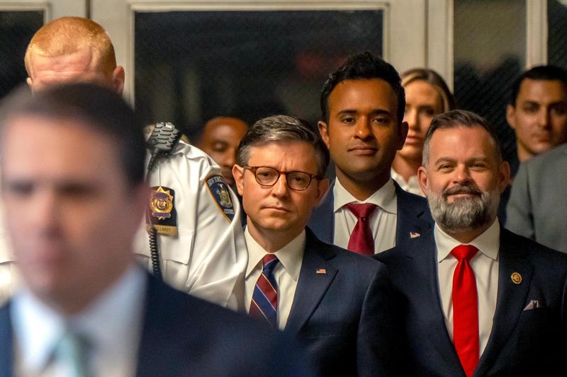 U.S. Speaker of the House Mike Johnson (R-LA) (L), businessman Vivek Ramaswamy (C), and Rep. Cory Mills (R-FL) listen as former U.S. President Donald Trump speaks to the media as he arrives with attorney Todd Blanche to court during his trial for allegedly covering up hush money payments at Manhattan Criminal Court on May 14, 2024 in New York City.