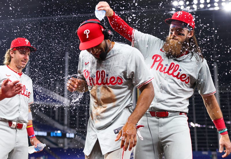 Brandon Marsh, #16 of the Philadelphia Phillies, dumps water on teammate Johan Rojas, #18, after defeating the Miami Marlins at loanDepot Park on May 10, 2024, in Miami, Florida.
