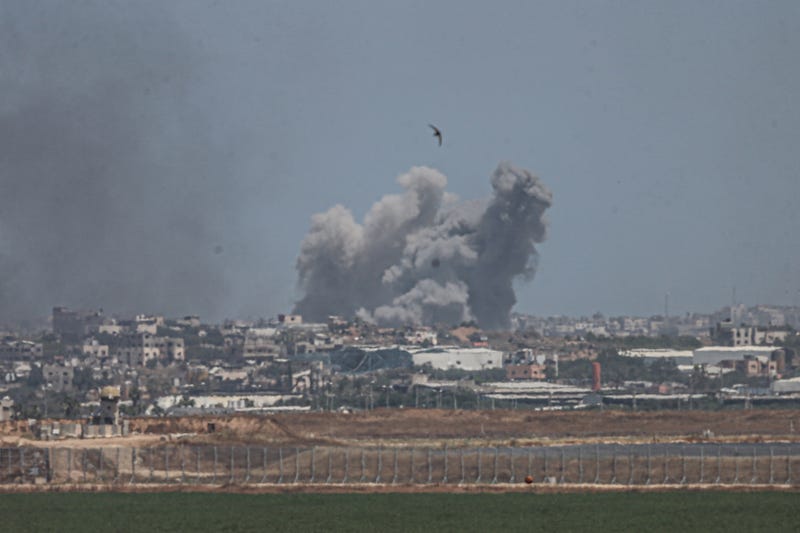A smoke plume from an explosion in the Gaza Strip is seen from a position along Israel's southern border on May 16, 2024