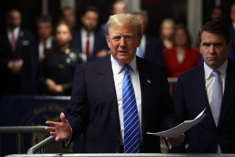 Former U.S. President Donald Trump speaks to the media with attorney Todd Blanche as he attends his trial for allegedly covering up hush money payments at Manhattan Criminal Court on May 13, 2024 in New York City.