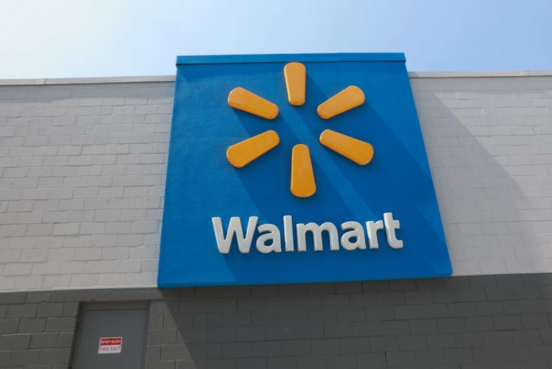 A sign hangs near a Walmart store