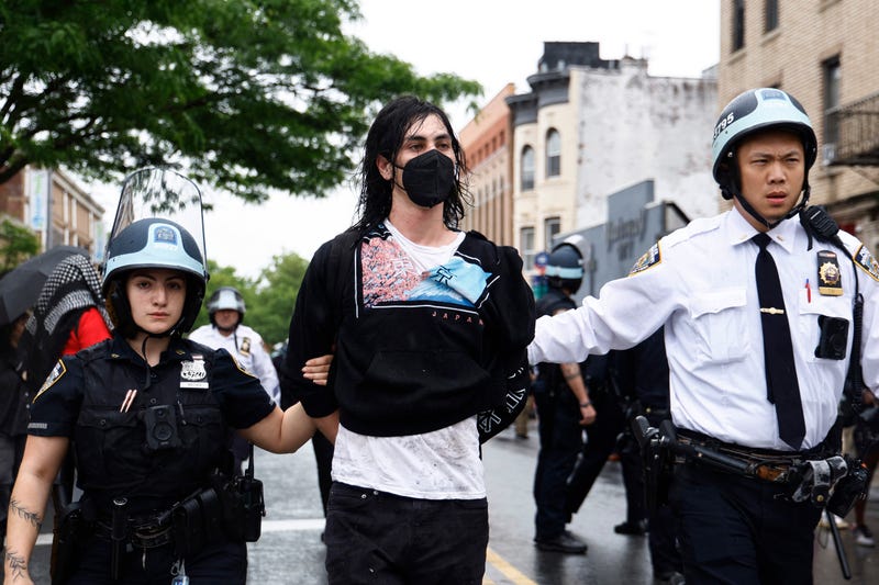 NYPD officers arrest pro-Palestinian demonstrators during a rally in Brooklyn on May 18, 2024. 