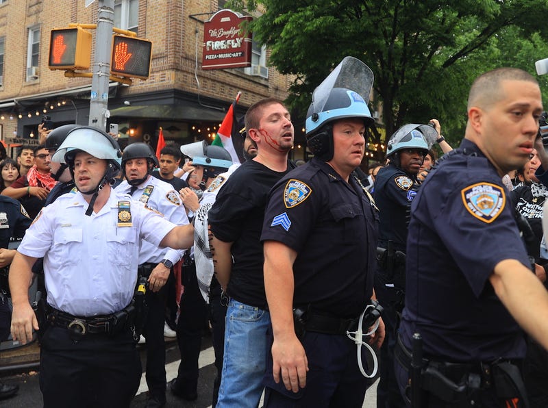 NYPD officers restrain pro-Palestinian protesters during a Nakba Day demonstration in Bay Ridge on May 18, 2024