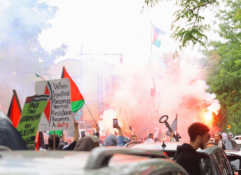 Protesters light flares in Bay Ridge during Saturday's protest