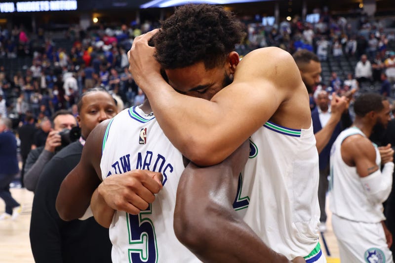 Karl-Anthony Towns #32 and Anthony Edwards #5 of the Minnesota Timberwolves hug after winning Game Seven of the Western Conference Second Round Playoffs against the Denver Nuggets at Ball Arena on May 19, 2024 in Denver, Colorado.