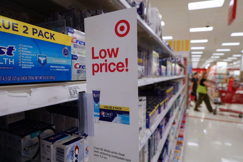 A low price sign hangs from a shelf at a Target store. Target announced plans to cut prices on thousands of consumer basics as inflation cuts into household budgets. 