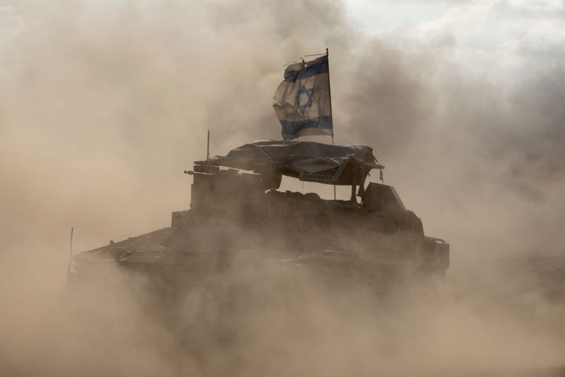 Israeli armored personnel carriers move along the border with the Gaza Strip on May 29, 2024 in Southern Israel, Israel.
