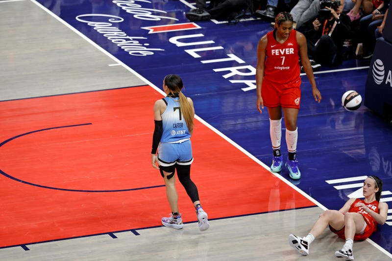  Chennedy Carter (7) is whistled for a flagrant foul for knocking Indiana Fever guard Caitlin Clark (22) to the ground.