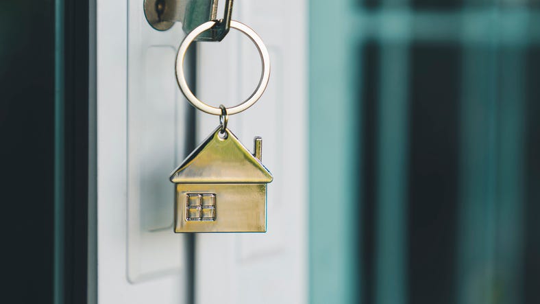 Home keychain hanging from a door. 