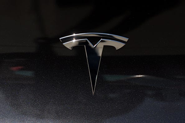 The Tesla logo is displayed on a brand new Tesla car on May 31, 2024 in Corte Madera, California. 