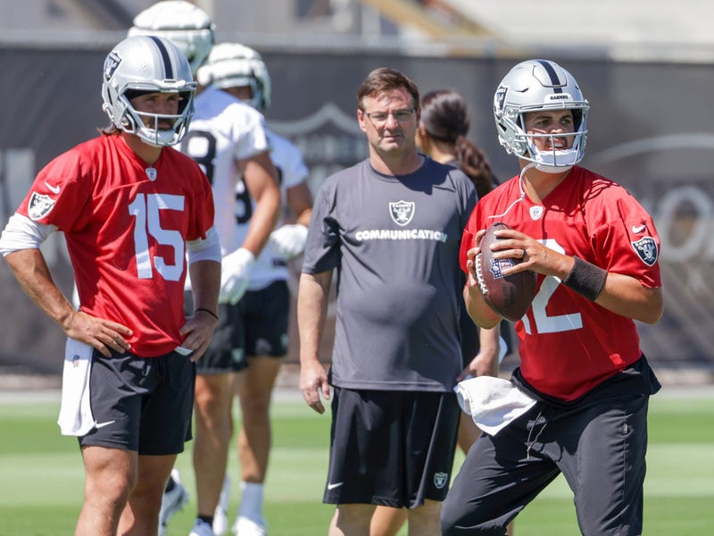 Quarterback Gardner Minshew #15 and quarterbacks coach Rich Scangarello of the Las Vegas Raiders watch as quarterback Aidan O'Connell #12 throws during an OTA offseason workout at the Las Vegas Raiders Headquarters/Intermountain Healthcare Performance Center on June 04, 2024.
