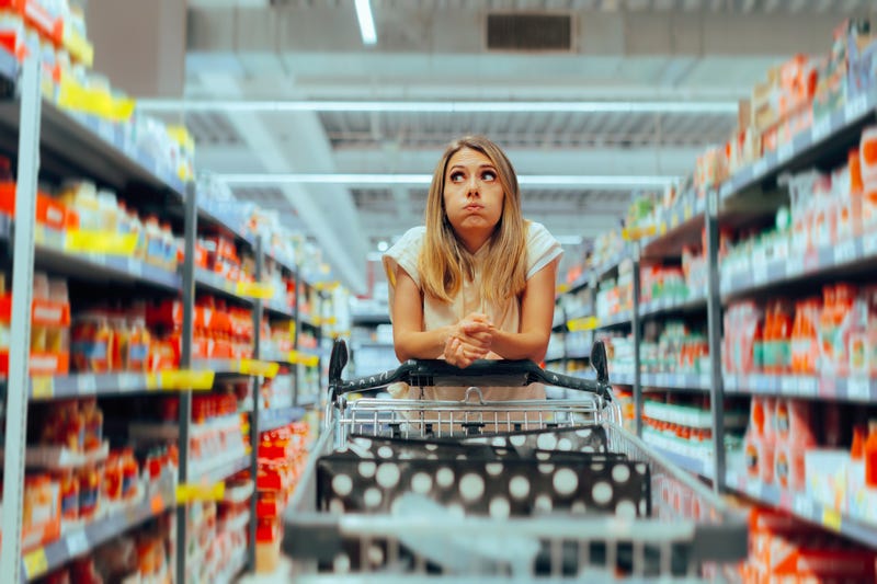 women in grocery store looking nervous