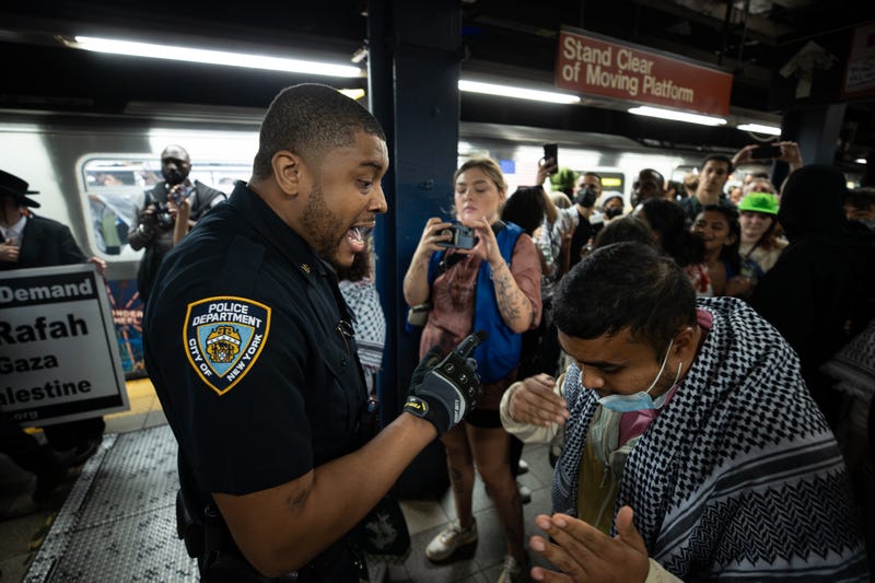 Police intervene inside the subway station as protesters gather at Union Square on June 10, 2024 in New York City. 