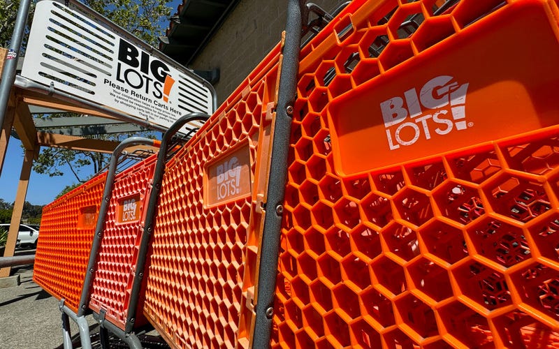 The Big Lots logo is displayed on shopping carts in front of a Big Lots store