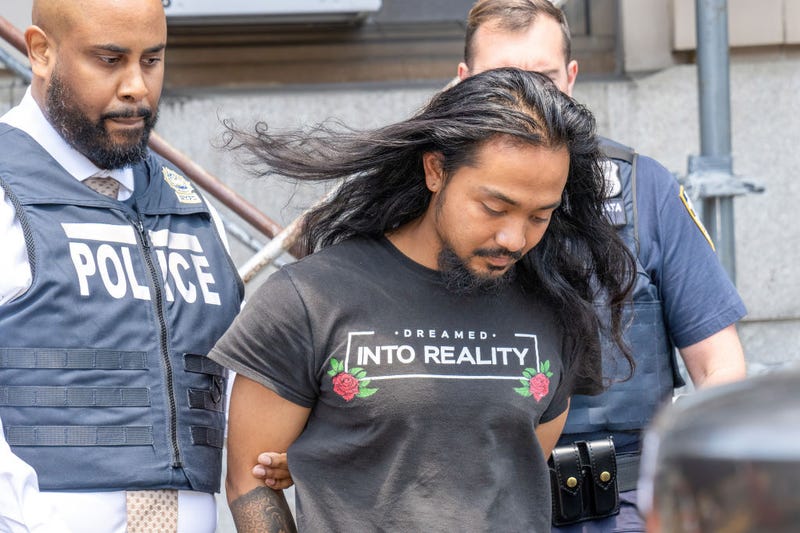 Judd Sanson is pictured in police custody leaving the New York Police Department 110th Precinct station house in Queens on Thursday, June 13, 2024.