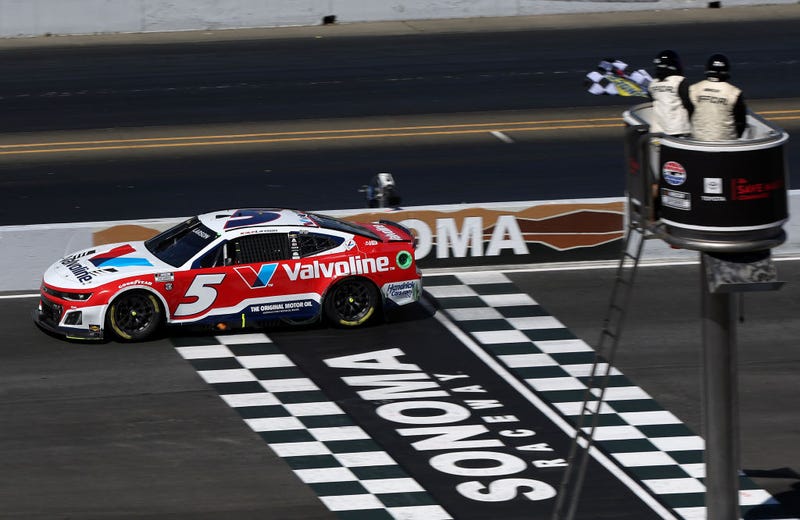 Kyle Larson, driver of the #5 Valvoline Chevrolet, takes the checkered flag to win the NASCAR Cup Series Toyota/Save Mart 350 at Sonoma Raceway on June 09, 2024 in Sonoma, California. 