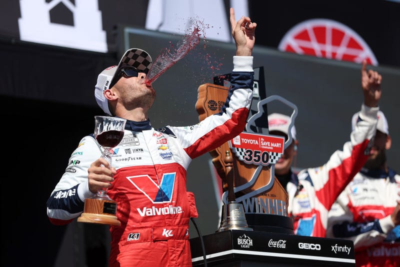  Kyle Larson, driver of the #5 Valvoline Chevrolet, celebrates with wine in victory lane after winning the NASCAR Cup Series Toyota/Save Mart 350 at Sonoma Raceway on June 09, 2024 in Sonoma, California.