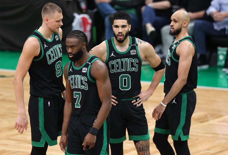 Kristaps Porzingis #8, Jaylen Brown #7, Jayson Tatum #0, and Derrick White #9 of the Boston Celtics look on during the second quarter against the Dallas Mavericks in Game Two of the 2024 NBA Finals at TD Garden on June 09, 2024 in Boston, Massachusetts. 