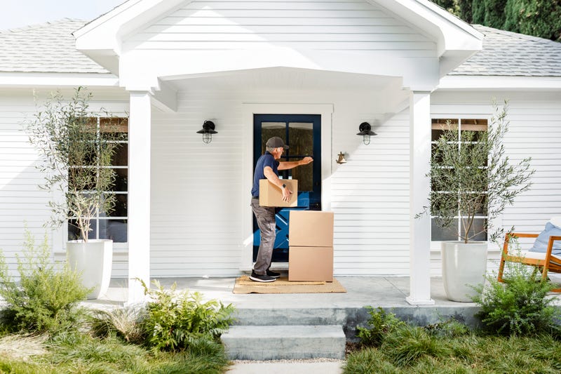 Man knocking on house door to deliver packages