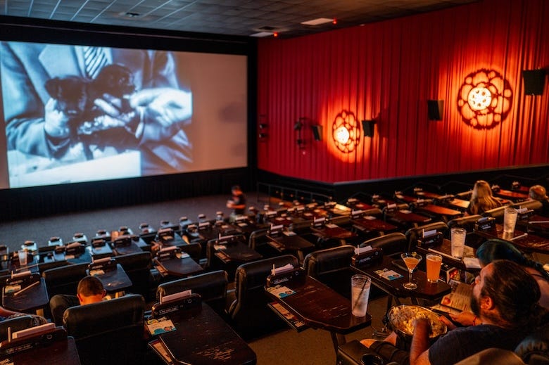 Moviegoers watching a film at Alamo Drafthouse