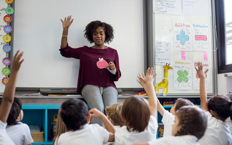 Teacher teaching in classroom stock photo