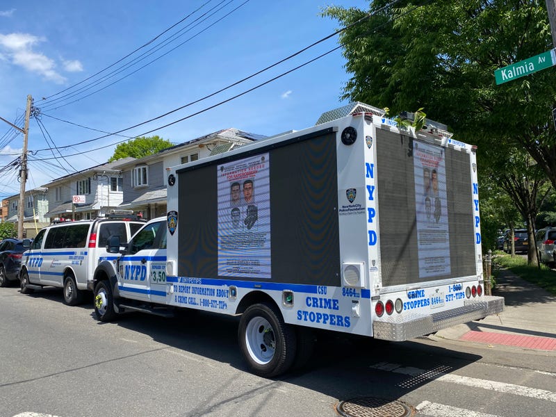 At Kissena Park, an NYPD vehicle with images on its exterior of the suspect who assaulted the two children, before he was apprehended.