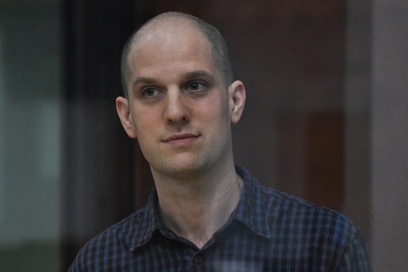 US journalist Evan Gershkovich, accused of espionage, looks out from inside a glass defendants' cage prior to a hearing in Yekaterinburg's Sverdlovsk Regional Court on June 26, 2024