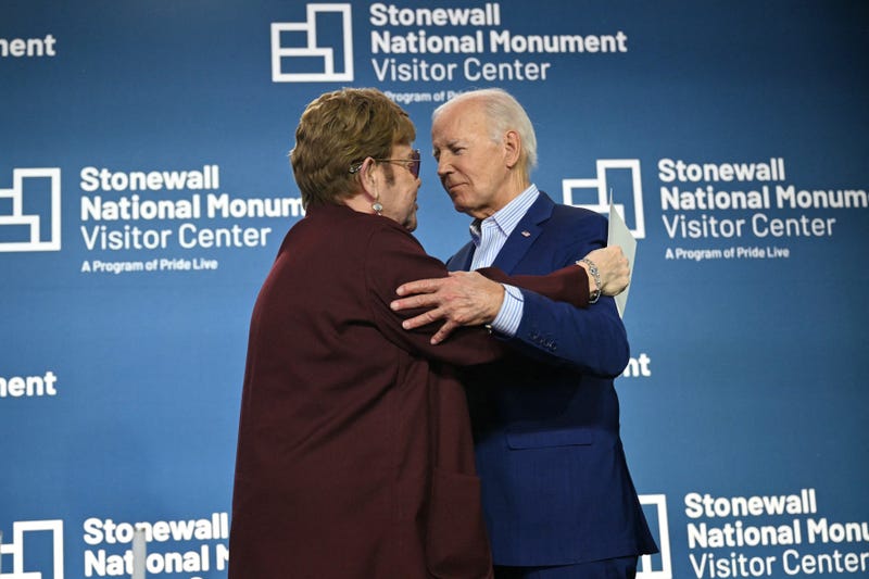US President Joe Biden greets British musician Elton John on stage at the Stonewall National Monument Visitor Center grand opening ceremony in New York on June 28, 2024. 