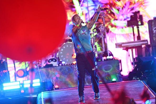 Chris Martin of the band ColdPlay perform on stage during day four of Glastonbury Festival 2024 at Worthy Farm, Pilton on June 29, 2024 in Glastonbury, England. Founded by Michael Eavis in 1970, Glastonbury Festival features around 3,000 performances across over 80 stages. Renowned for its vibrant atmosphere and iconic Pyramid Stage, the festival offers a diverse lineup of music and arts, embodying a spirit of community, creativity, and environmental consciousness. (Photo by Joe Maher/Getty Images)