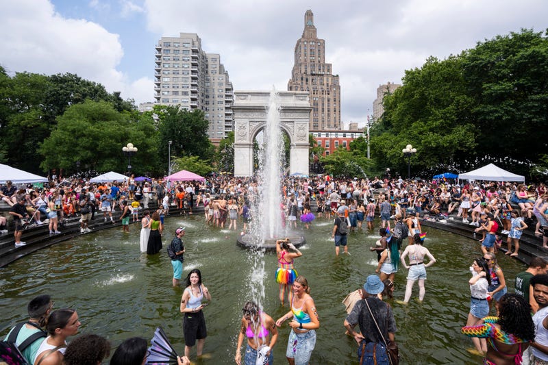 People celebrate in Washington Square Fountain at Washington Square Park after the New York City Pride March on June 30, 2024
