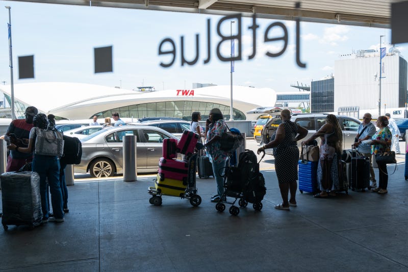 People move through a crowded JFK International Airport