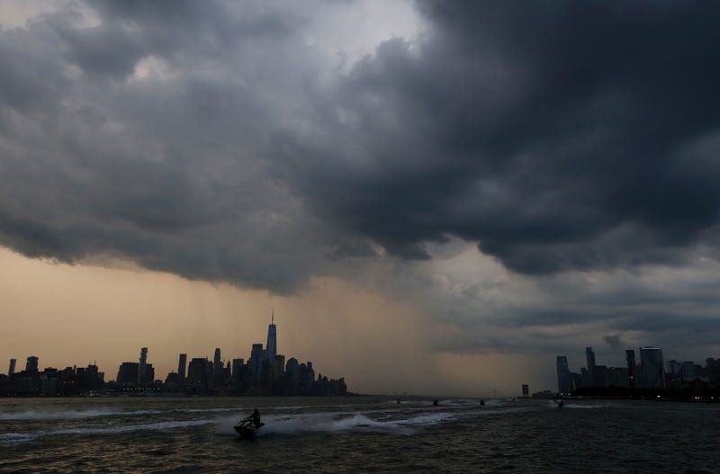 Storm clouds pass over lower Manhattan and One World Trade Center in New York City on July 5, 2024, as seen from Hoboken