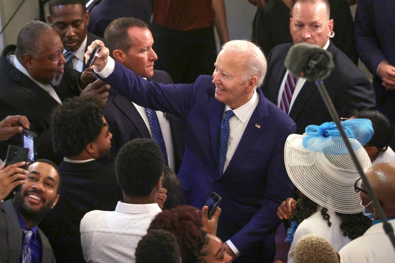 U.S. President Joe Biden poses with supporters