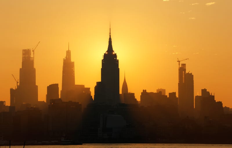 The sun rises behind the Empire State Building on July 8, which was the hottest day of the year so far in Central Park